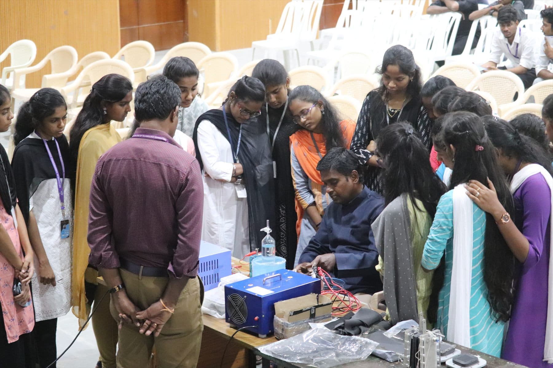 A student cohort gathered around a working fuel cell demonstration