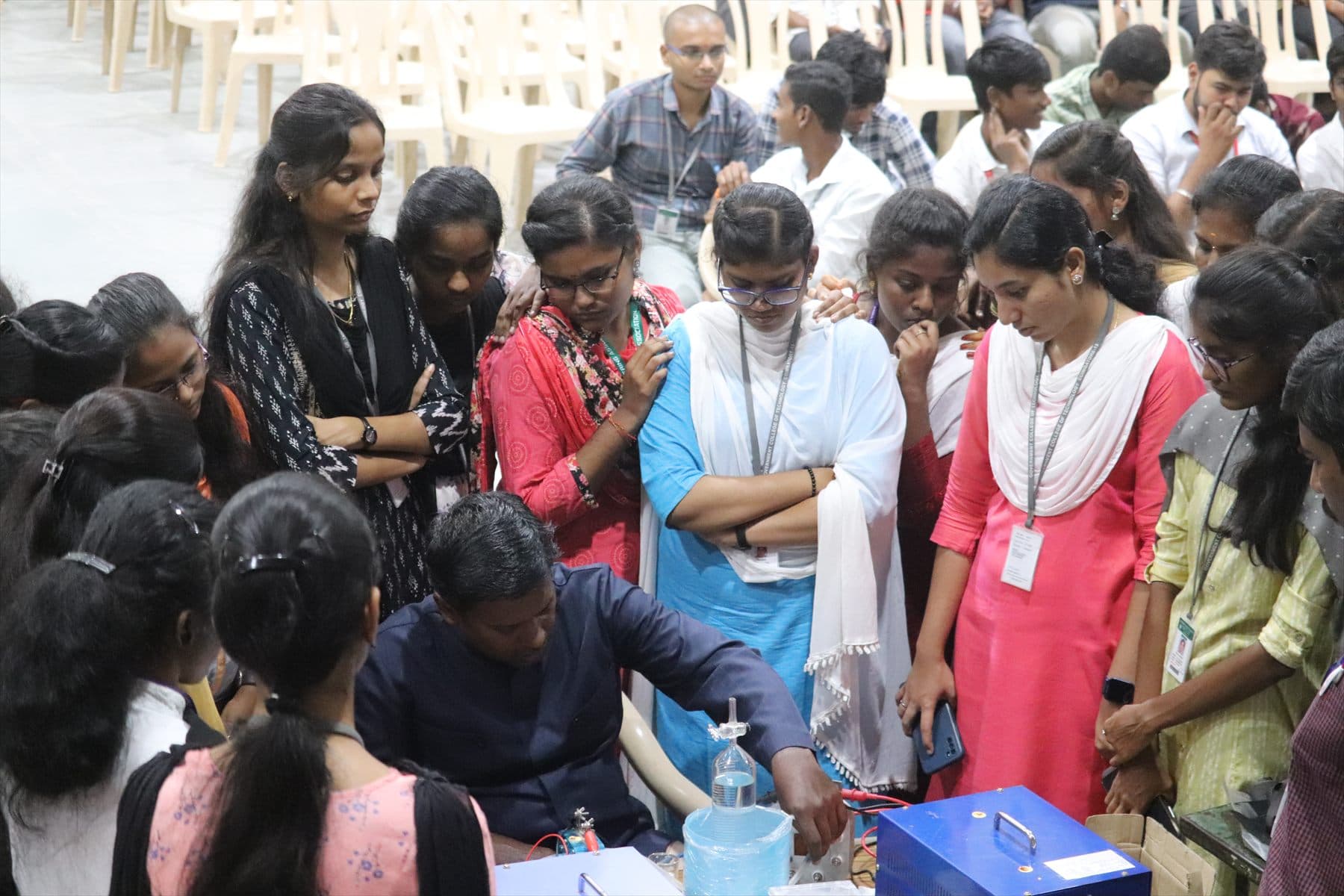 A cohort gathered around a working fuel cell during a training session